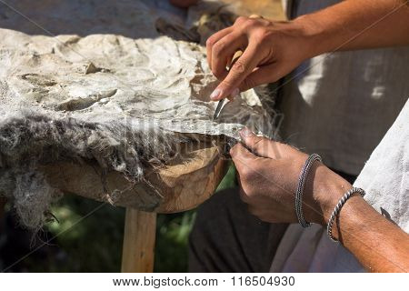The Craftsman Works With The Skin Of An Animal