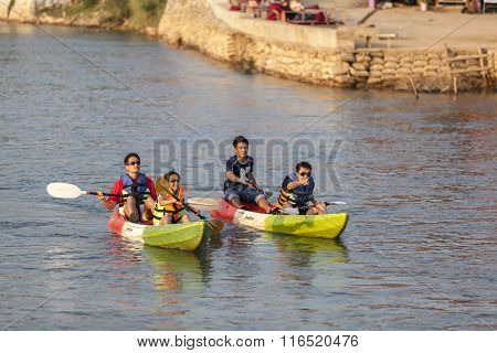 Unidentified Tourists Are Rowing Kayak Boats In Song River.