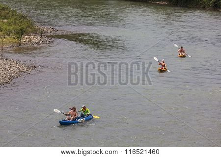 Unidentified Tourists Are Rowing Kayak Boats In Song River.