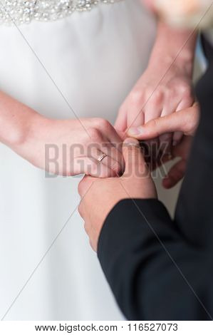 Bride and groom holds hands