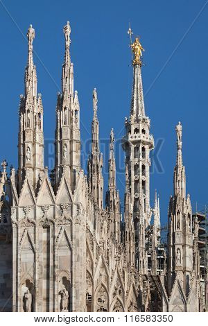Gilded bronze statue of the Virgin Mary called the Madonnina on the spire of the Milan Cathedral in Milan, Lombardy, Italy.