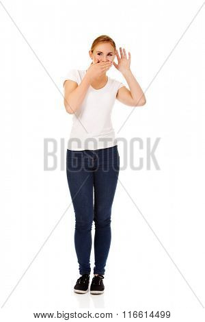 Young woman overhears conversation and giggles
