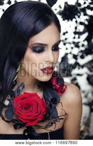 pretty brunette woman with rose jewelry, black and red, bright make up kike a vampire closeup red li
