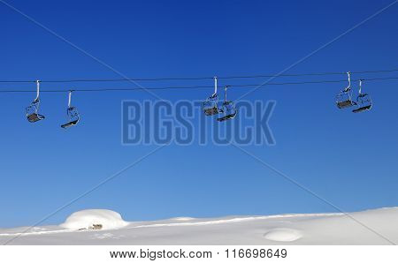 Chair-lift And Blue Clear Sky At Sun Day