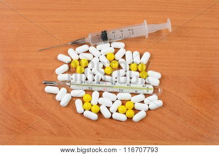 Thermometer With Pills And A Syringe