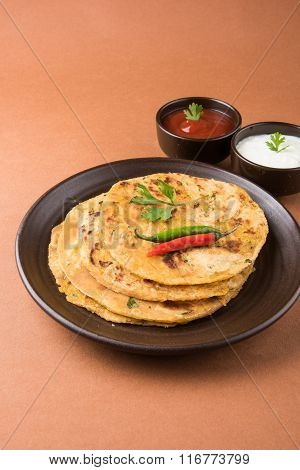 Traditional Indian bread - Aloo paratha or aalu parotha, potato stuffed bread. served with tomato ke