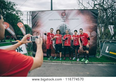 Runners team posing in front of official banner before the race