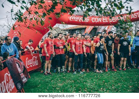 Runners in a extreme obstacle race on start line ready to run