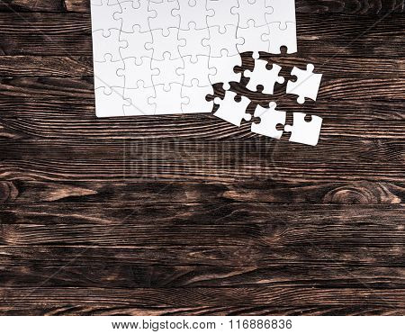 white uncompleted puzzle from one side and text space
