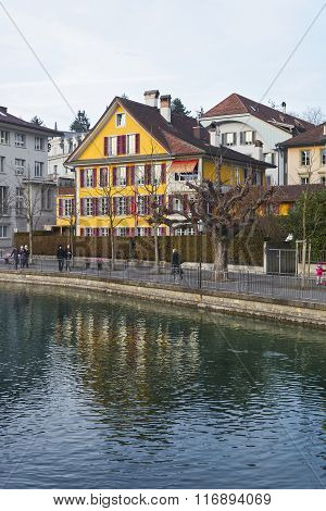 Thun, Switzerland - January 1, 2014: Houses on the Embankment in the Old City of Thun in Switzerland. Thun is a city in Swiss canton of Bern. It is located where Aare river flows out of Lake Thun.