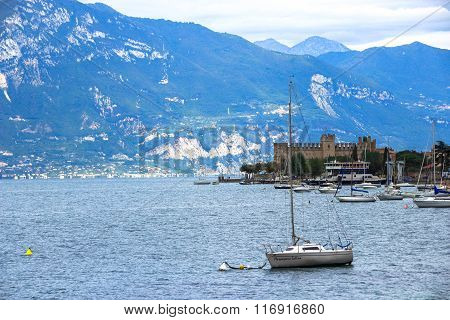 The yacht on the background of the fortress and the mountains