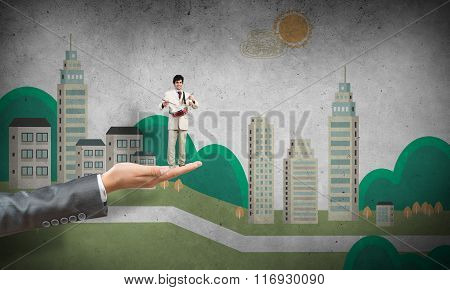 Palm supporting businessman