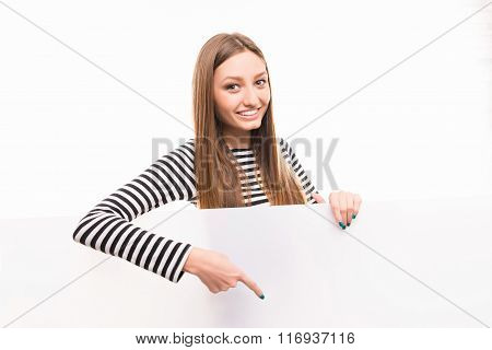 Positive Happy Girl Pointing Down To The Empty Space