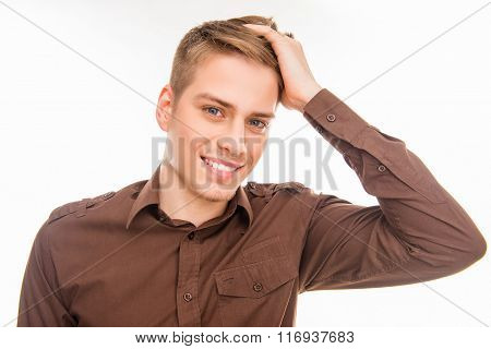 Handsome Young Smiling Man In Brown Shirt Touhing His Hair