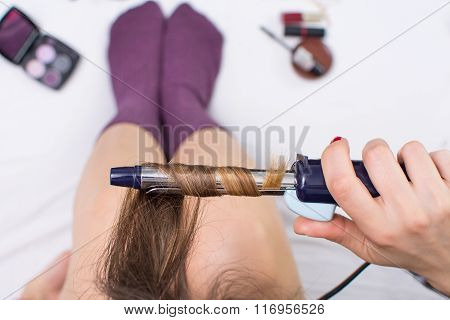 Girl Straightening Her Hair In Bed