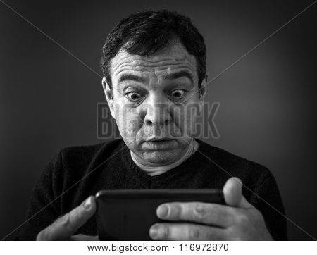 Bad news.  Portrait by shocked man. Black and white photo