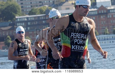 STOCKHOLM - AUG 22 2015: Joao Pereira (POR) and group of male swimmers climbing up from the water in the Men's ITU World Triathlon series event August 22 2015 in Stockholm Sweden