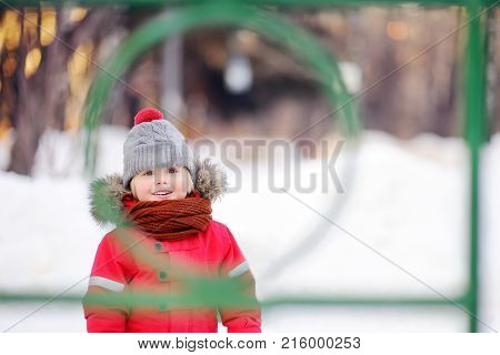 Little Boy In Red Winter Clothes Having Fun On Outdoor Playground