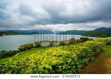Dam behind a Green Garden with dark cloudy at the Southern of Thailand Surat Thani