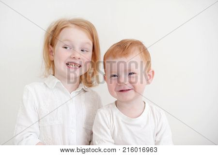 Redheaded funny kids on a white background