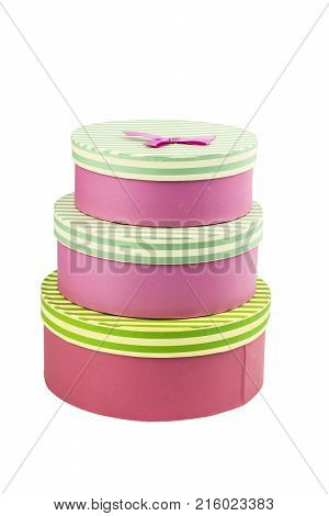 three pink cirkle gift boxes with circle striped box cover with pink ribbon and a bow isolated on white background