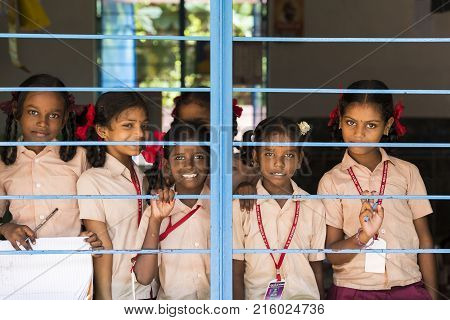 PONDICHERY PUDUCHERY INDIA - SEPTEMBER 04 2017. Unidentified child at schhol behind the window