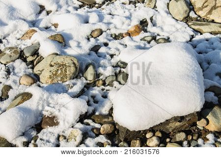 Stones Covered With Snow In A Winter Forest On A Sunny Day.