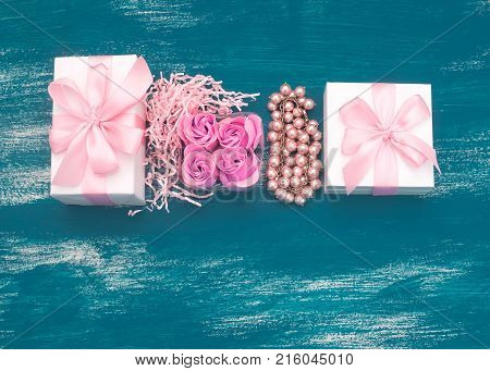 Decorative composition holiday boxes with gifts. Womens costume jewelry flowers. Flat lay