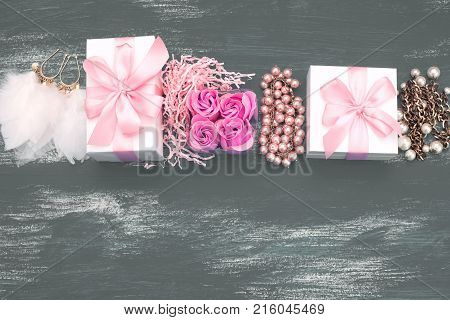 Decorative composition holiday boxes with gifts. Womens costume jewelry flowers. Flat lay