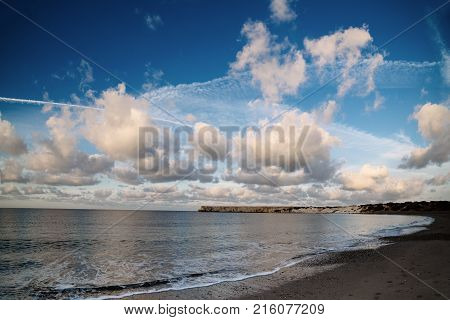Beautiful sealandscape with dramatic clouds over blue sky and soft waves. Beauty world natural outdoors travel background