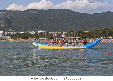Gelendzhik, Krasnodar region, Russia - 16 July 2015: Beach activities resort city of Gelendzhik. People ride on an inflatable banana boat in Gelendzhik Bay