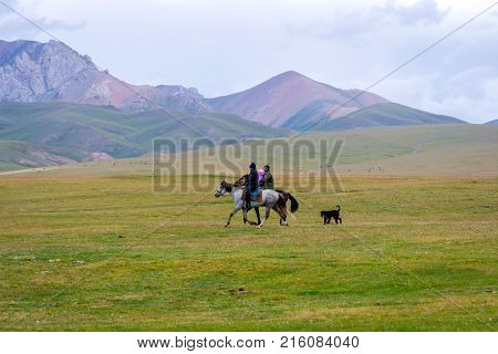 Pair Riding The Horses With A Kid, Kyrgyzstan