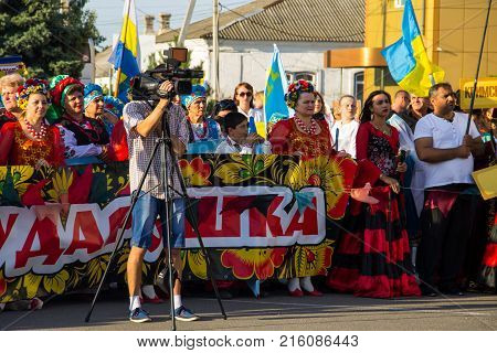 Genichesk, Ukraine - August 26, 2017: Video camera operator working with his professional equipment at Festival of National Cultures Tavriyska rodyna (Tavria Family)