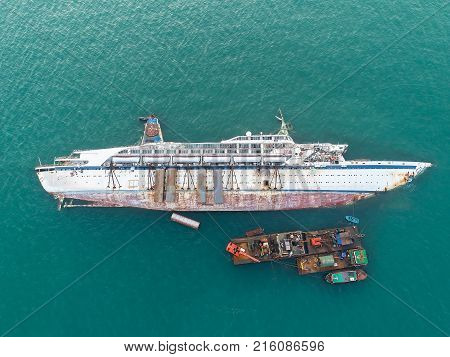 Boat crashes in the sea cruise ship accident Ship wreck.disaster of the passenger vessel capsize and sunk into the sea ocean at sunset in aerial view
