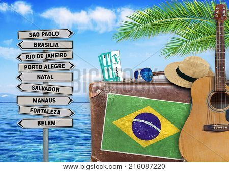 Concept of summer traveling with old suitcase and Brazil town sign