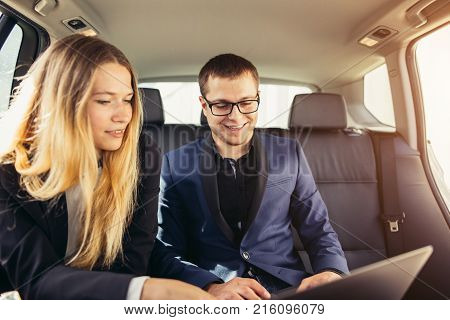 Business people having disccusion in the limousine