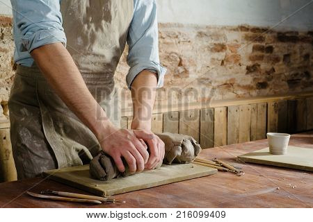 Pottery Clay Ceramics Art Concept - Closeup On Hands Of Young Master With The Large Pieces Of Firecl
