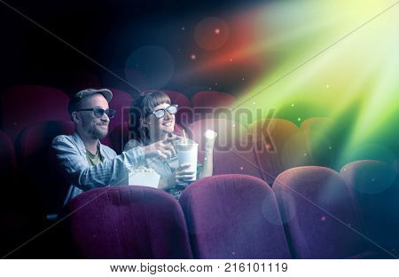 Teenager couple cuddling and watching the climax part of the movie