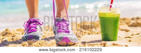 Green smoothie runner fitness woman banner. Panorama crop of person tying running shoes at beach workout. Healthy lifestyle detox weight loss girl lacing trainers.