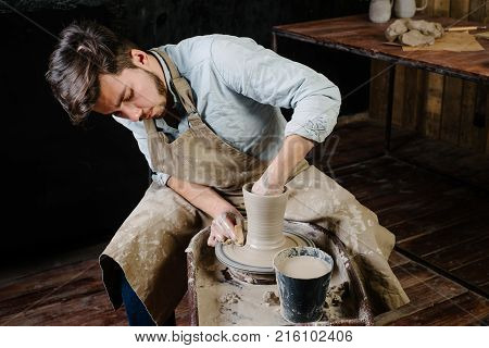 Handsome Young Mexican Potter Does Sketches Of Ceramics On The Paper. Concept Of Small Business, Han