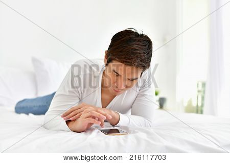Men are playing mobile in the bedroom.