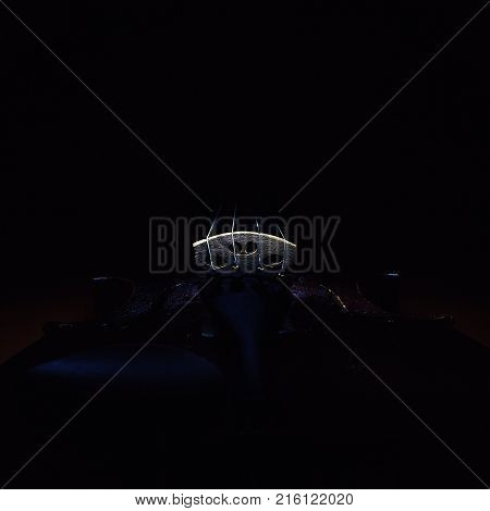 Accentuated shapes of violin with light illuminated in dark.