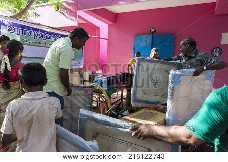 PONDICHERY PUDUCHERY INDIA - SEPTEMBER 04 2017. Outdoor meeting of the children of the school with uniforms sitting on the floor waiting for sport equipments as a gift from an association.