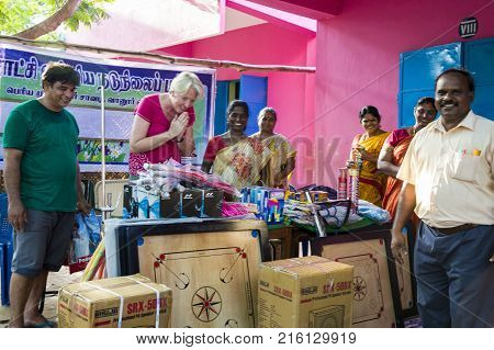 PONDICHERY PUDUCHERY INDIA - SEPTEMBER 04 2017. Outdoor meeting of the children of the school with uniforms sitting on the floor waiting for sport equipments as a gift from an association.