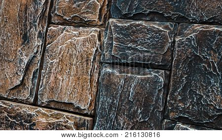 Decorative brick wall from concrete facing tiles as background or texture.