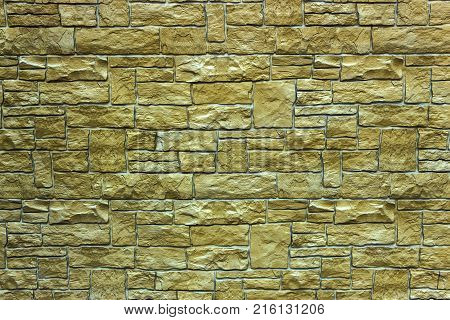 Decorative brick wall from concrete facing tiles as background or texture.