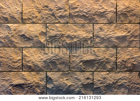 Decorative brick wall from concrete facing tiles as background or texture.