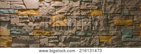 Decorative brick wall from concrete facing tiles as background or texture.
