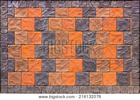 Decorative brick wall from concrete facing tiles as background or texture.