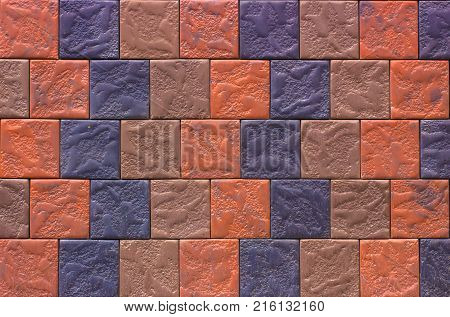 Decorative brick wall from concrete facing tiles as background or texture.
